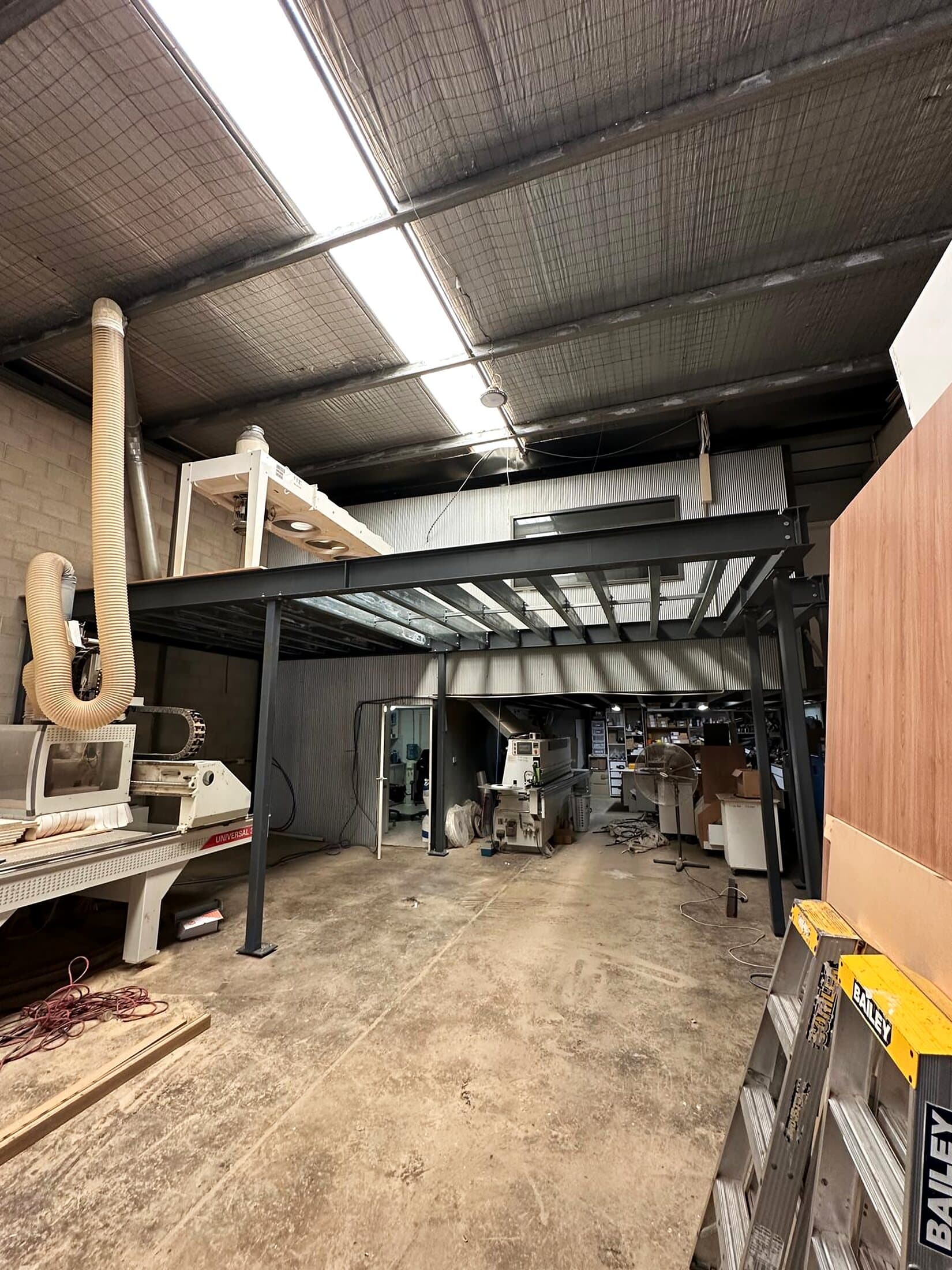 Steel mezzanine installed inside an operating workshop