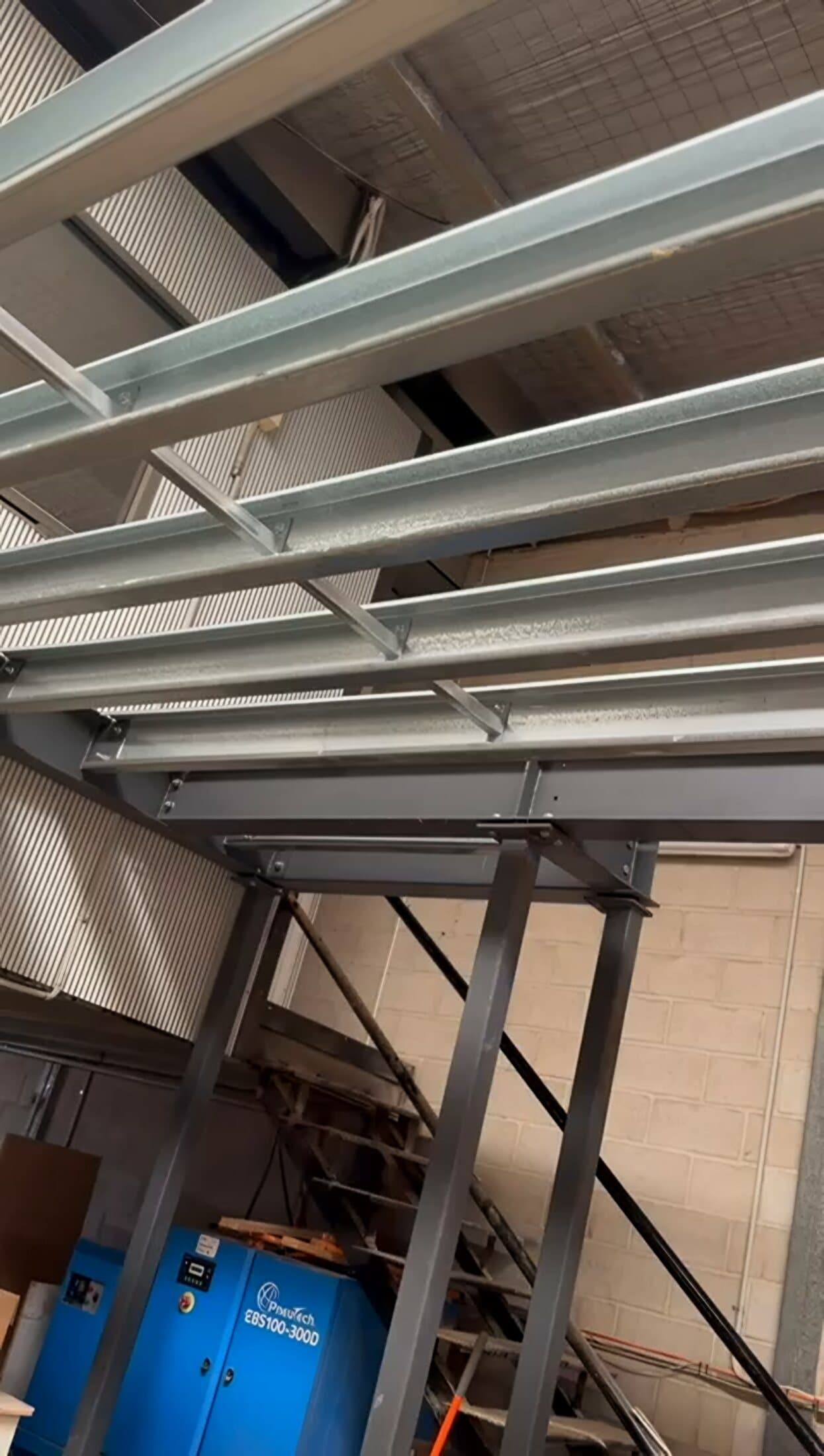 Steel mezzanine stair and framing inside a workshop