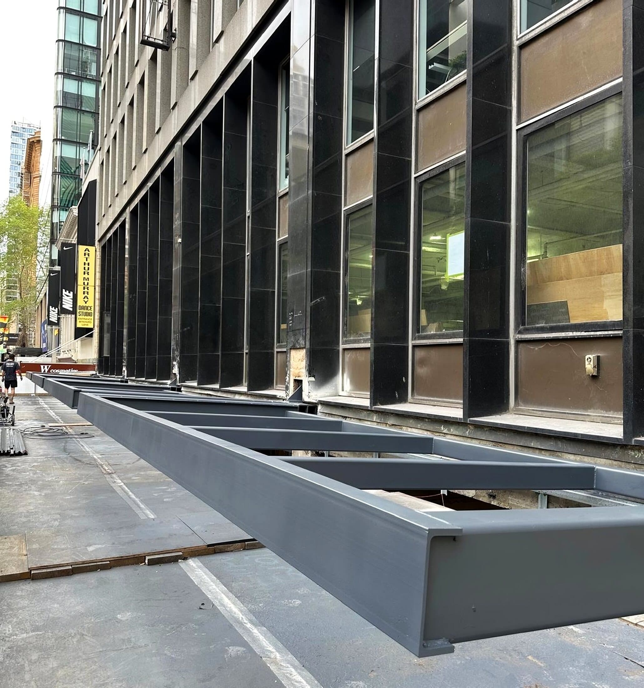 Fabricated steel facade frames laid out along a city street