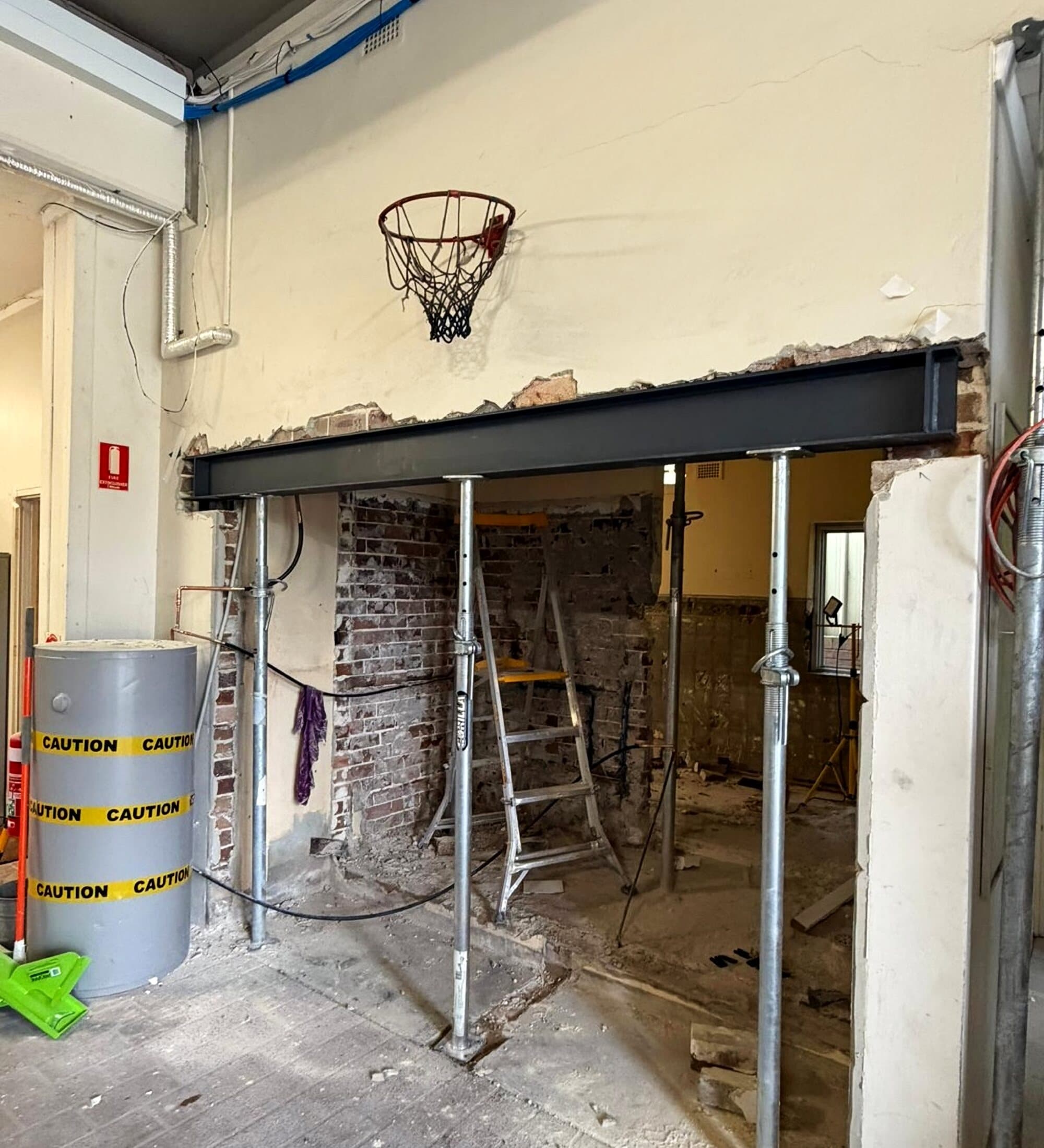 New steel beam on temporary props over an enlarged opening