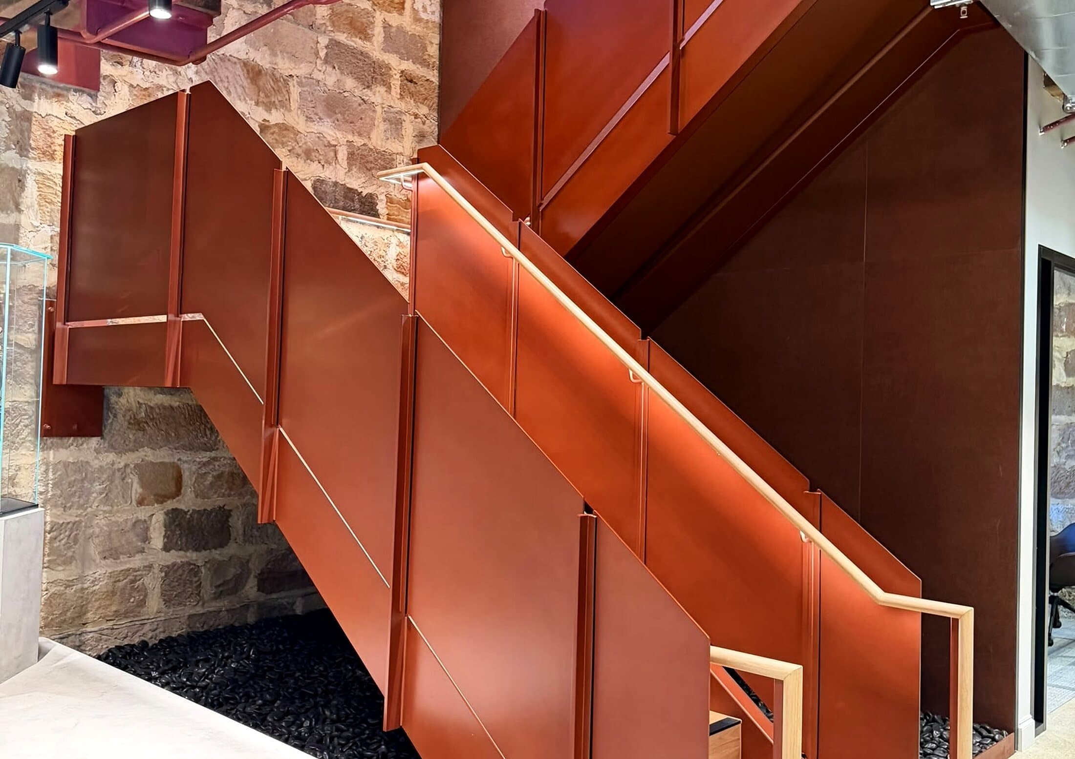 Steel feature stair with a timber handrail